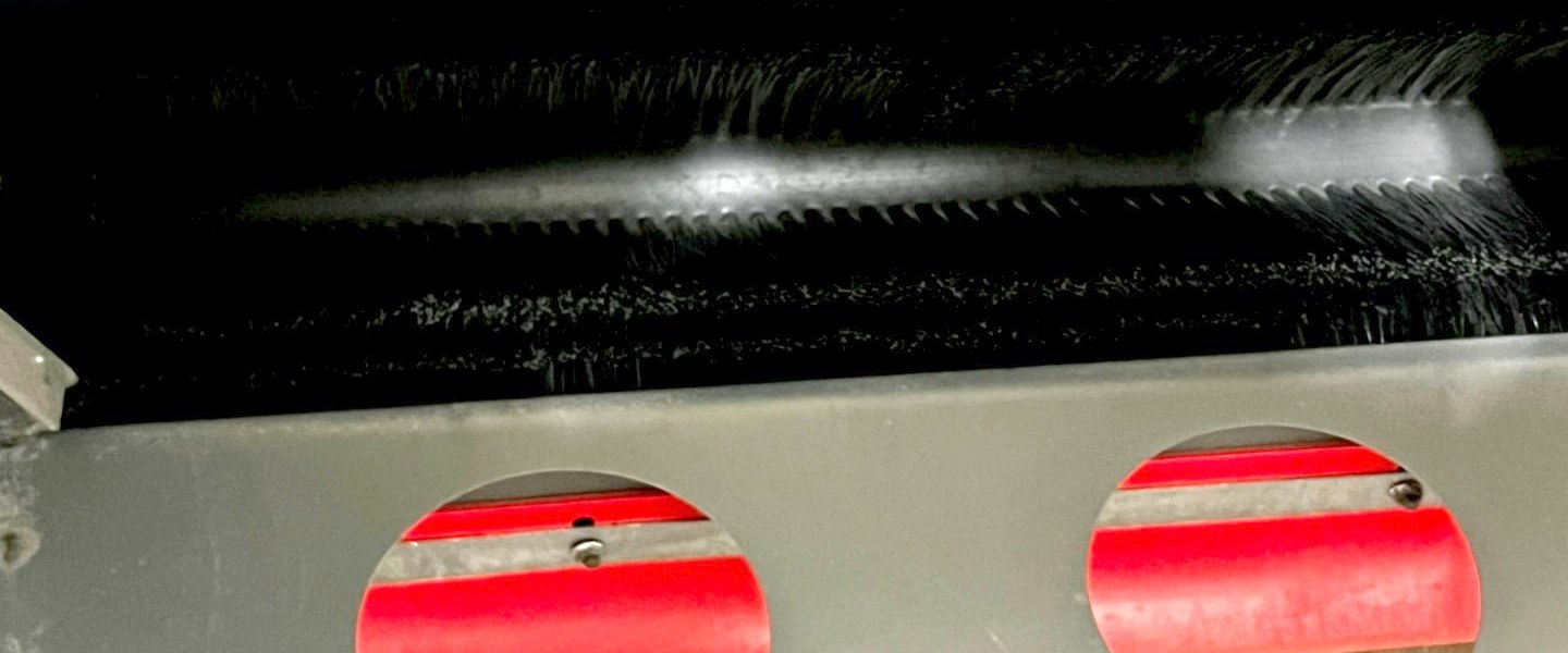 The TurfBoni™ FiberLift™ rotating brush assembly that lifts and restores matted turf fibers